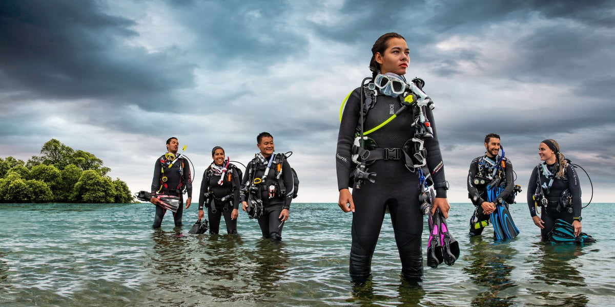 Group of divers standing in shallow water