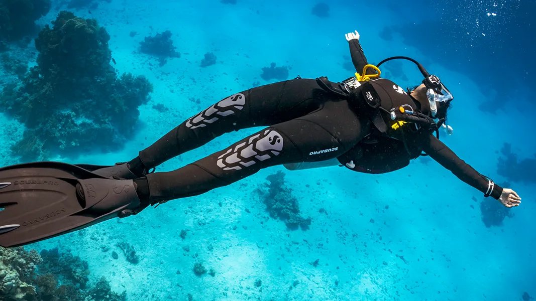 Instructor demonstrating underwater