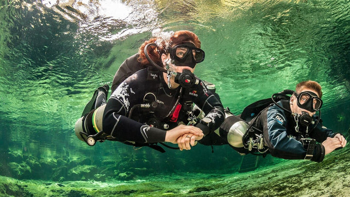 Sidemount diver in green water